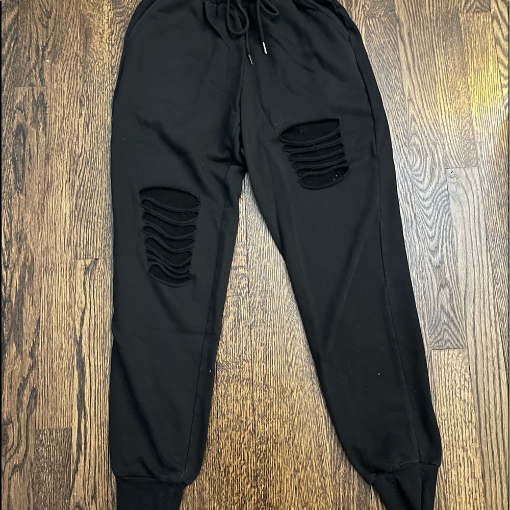 black sweatpants with rip design